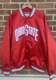 Head to the game in style with this Ohio State Buckeyes Red Lightweight Satin Track Jacket! Show off your Buckeyes pride in this Athletic Jacket, which features a embroidered tackle twill team wordmark on front chest. Go Buckeyes! Game Day Long Sleeve Winter Track Jacket, Long Sleeve Track Jacket For Game Day In Winter, Sporty Hooded Outerwear For Game Day, Winter Long Sleeve Track Jacket For Game Day, Team-colored Outerwear With Team Name For Sports Season, Team-colored Outerwear With Team Name For Game Day, Team-colored Collegiate Outerwear For Sports Events, Hooded Varsity Outerwear For Game Day, Winter Game Day Long Sleeve Outerwear