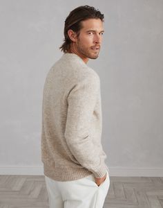 Alpaca, cotton and wool cardigan with metal buttons Accurate materials research and the iconic knitting of Brunello Cucinelli knitwear enhance the classic feel of this alpaca, cotton and wool cardigan. The blend of natural yarns gives the garment a soft and compact hand, delivering comfort and warmth. The regular fit is complemented by metal buttons. Timeless Wool Sweater For Fall, Timeless Wool Sweater For Winter, Classic Alpaca Sweater For Winter, Classic Beige Knitted Sweater Coat, Classic Knitted V-neck Sweater For Fall, Classic Crew Neck Sweater With Button Cuffs, Classic Long Sleeve Lambswool Sweater, Classic Beige Wool V-neck Sweater, Classic Cashmere Outerwear With Textured Knit