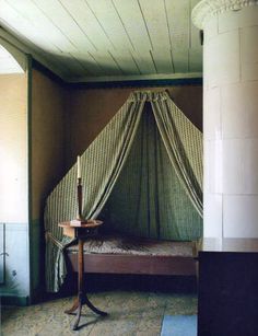 a bed sitting in the corner of a room