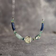 This unique necklace is made with ancient Roman Empire-era glass beads sterling silver beads and silver cable chain. Available 14-18 inches long. Each jewelry comes wrapped in a gift box securely wrapped for shipping. Matching roman glass earrings could be found in my shop hire: https://www.etsy.com/uk/listing/1159985037/ancient-roman-glass-earrings-roman?click_key=9aeb1b70d404d67d518d2172d03e1115d0f2bb1f%3A1159985037&click_sum=496de735&ref=shop_home_active_1 Silver Glass Necklace With Gemstone Beads, Sterling Silver Beaded Necklace Gift, Glass Jewelry With Silver Beads For Gifts, Silver Gemstone Beads Necklace With Glass Material, Artisan Sterling Silver Beaded Necklaces As Gifts, Artisan Beaded Necklace With Sterling Silver Clasp, Artisan Sterling Silver Beaded Necklace For Gift, Gift Necklace With Recycled Glass Round Beads, Recycled Glass Round Beads Necklace As A Gift