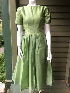 1950's green party dress with full skirt. Size extra small.Great condition.24" waist33" bust Vintage Fitted A-line Tea Length Dress, Green Evening Dress With Pleated Waist, Vintage A-line Dress With Pleated Waist, Fitted Green Dress With Pleated Bodice, Fitted Green Tea-length Dress, Green Pleated Bodice Cocktail Dress, Green Tea Length Dress For Wedding, Green Tea-length Summer Dress, Green Tea-length Wedding Dress