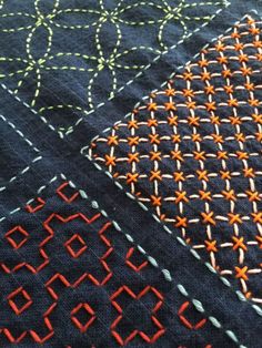 closeup of an orange and black piece of cloth with stitching on it's edges