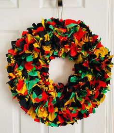 a colorful wreath hanging on the front door