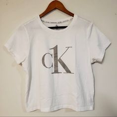 Size L. Never Worn Calvin Klein White Logo Print T-shirt, Calvin Klein Cotton Tops For Loungewear, Calvin Klein Basic Short Sleeve Tops, Calvin Klein Cotton Loungewear Tops, Calvin Klein Summer Loungewear Tops, Fitted Calvin Klein Crew Neck Top, Calvin Klein Fitted Crew Neck Top, Calvin Klein Crew Neck Tops For Loungewear, Calvin Klein White Short Sleeve Top