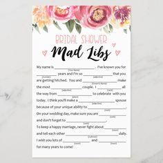 the bridal shower mad - libs game is shown on a marble surface with pink flowers