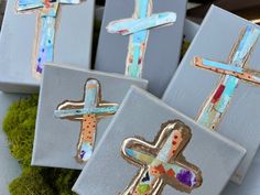 three painted crosses sitting on top of each other