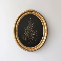 an ornate gold framed christmas tree with berries on it is shown in the middle of a white wall