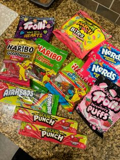 many different types of candy are on the counter