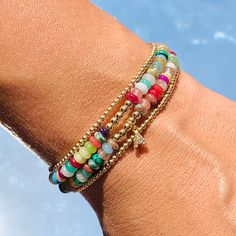 Our Gaby Beaded Bracelet is a harmonious fusion of vibrant hues and luxurious accents. This bracelet is a celebration of color, adorned with carefully selected beads that exude a lively charm. The rainbow of beads, each reflecting a different shade, creates a playful yet elegant palette that's perfect for brightening up your day. Amidst this burst of color, a delicate gold beads weaves its way, adding a touch of sophistication and warmth. Size: 7" + 2" Extension Does not include Initial Charm Adjustable Multicolor Faceted Beads Bracelets, Colorful Beaded Bracelets For Party, Colorful Bohemian Beaded Bracelets For Party, Multicolor Bangle Charm Bracelet For Party, Bohemian Multicolor Adjustable Pearl Bracelet, Multicolor Beaded Spiritual Crystal Bracelet, Party Bracelets With Colorful Round Beads, Adjustable Multicolor Pearl Bracelet With Colorful Beads, Adjustable Multicolor Hand-strung Pearl Bracelet