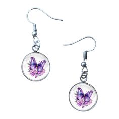 a pair of earrings with purple butterflies on them, hanging from silver earwires