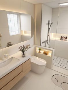 a bathroom with a sink, toilet and shower in it's center piece is illuminated by recessed lighting