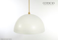 a white lamp hanging from a gold colored cord with the word codero on it