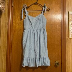 Old Navy Dress, Size Medium, Chambray Blue, New With Tag, Cami Style, Ties On Shoulders, Mini With Pockets, See Picture Of Tag For Material And Washing Instructions Blue Fitted Sundress With Tie Straps, Blue Sundress With Tie Straps For Brunch, Casual Blue Sundress With Tie Straps, Casual Light Blue Mini Dress With Tie Back, Light Blue Casual Mini Dress With Tie Back, Light Blue Casual Dress With Adjustable Straps, Casual Light Blue Dress With Adjustable Straps, Light Blue Casual Dress With Tie Back, Blue Cotton Mini Dress With Tie Straps