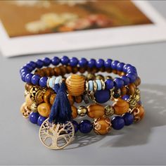 Experience Gorgeous, Unique Style With The Tree Of Life Bracelet 4 Piece Set! This Vibrant Set Is Intricately Crafted With Four Distinct Pieces, Each Adorned With An Eye-Catching Tree Of Life Design. Accessorize Your Wardrobe With A Touch Of Flair And Express In A Way You Never Thought Possible! - Vintage Wooden Bead Multi-Layer Bracelet - Fashion And Elegant Design - Exquisite Beaded Bracelet Is The Adornment Of The Women, It Will Add Shine To Your Appearance. - Elastic, Multi-Layer, Wooden-Bea Blue Bohemian Beaded Bracelets With Large Beads, Bohemian Blue Beaded Bracelets With Wooden Beads, Blue Bohemian Beaded Bracelets With Wooden Beads, Bohemian Blue Bracelets With Wooden Beads, Blue Wooden Beaded Bracelets For Beach, Hippie Blue Round Bead Bracelets, Hippie Blue Bracelets With Round Beads, Blue Wooden Beads For Festival, Blue Wooden Beads Bracelet