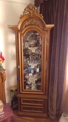 a grandfather's china cabinet with pictures on it