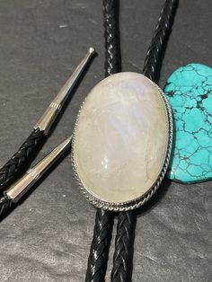 *Moonstone Bolo tie with silver tips *Sterling Silver *Free Shipping *Handcrafted In USA *Jewelry ship in Gift box * Ready to ship * Rainbow Moonstone Cabochons bolo Thank You For Your Looking ,And Check Out More Items In My Etsy Shop For More Great Deals, Also We Add More Jewelry To Etsy Shop regularly PLEASE check their dimensions, before setting the order. NOTE -Once the parcel gets shipped out, it is usually needed 3-6 business days for every where in US Please keep in mind that once your pa Adjustable Sterling Silver Jewelry With Large Stone, Adjustable Moonstone Jewelry With Round Stone, Adjustable White Gemstone Jewelry, Adjustable White Artisan Jewelry, Adjustable Artisan White Jewelry, Artisan White Stone Jewelry, Classic Adjustable Jewelry With Large Stone, Adjustable Moonstone Jewelry For Formal Occasions, Classic Adjustable White Moonstone Ring