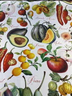 a table cloth with an assortment of fruits and vegetables printed on it's surface