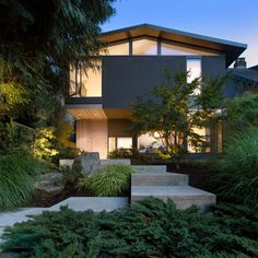 a modern house with steps leading up to it