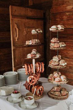 a table topped with lots of donuts and pastries