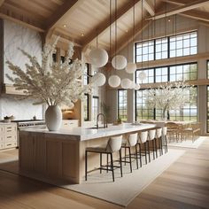 a large open kitchen with lots of counter space and white vases on the island