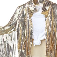 Vintage western style meets modern cowgirl, the gold sequin fringe bolero jacket makes the perfect outfit accent for any occasion where you want to be the center of attention. The sequins + fringe that adorn the jacket glisten and sway as you move, adding extra sparkle to every step. Comfortable, light, and easy to wear, it's perfect for layering over any outfit, whether it be for a music festival, a night out, a bachelorette or bridal shower, and so much more. Once you put it on, you'll never w Gold Sequined Outerwear For Spring, Fall Party Outerwear With Rhinestone Fringe, Spring Party Outerwear With Rhinestone Fringe, Gold Outerwear For Night Out And Party Season, Gold Outerwear For Party Season Night Out, Gold Outerwear For Party Season And Night Out, Fitted Fringe Outerwear For Parties, Fitted Party Outerwear With Fringe, Gold Festive Outerwear For Spring