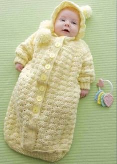 a baby in a crocheted sleeping bag