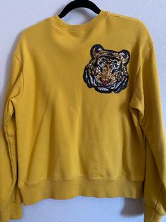 One of a kind sweatshirt with sequin tiger + heart patch. Size: Women's Medium Casual Crew Neck Sweater With Sequins, Casual Embroidered Sweatshirt For Fall, Casual Sequin Tops For Fall, Streetwear Long Sleeve Tops With Embroidered Patch, Embroidered Patch Tops For Streetwear In Fall, Long Sleeve Tops With Embroidered Patch For Winter, Winter Long Sleeve Tops With Embroidered Patch, Embroidered Long Sleeve Winter Tops, Fall Sequin Long Sleeve Sweatshirt