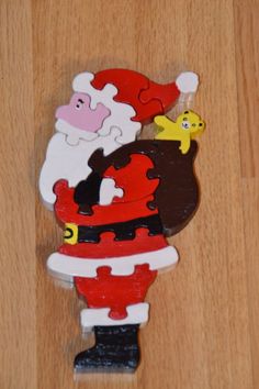 a santa clause holding a bird on top of a wooden floor