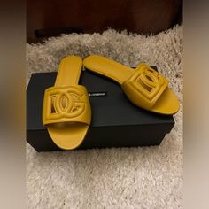 This Versatile Slide Sandal Is Topped With A Dimensional Dg Logo For Added Volume. Made In Italy Elegant Yellow Sandals With Round Toe, Designer Yellow Leather Sandals, Luxury Yellow Sandals For Summer, Designer Yellow Sandals For Beach, Designer Yellow Sandals For The Beach, Luxury Yellow Leather Sandals, Chic Flat Yellow Sandals, Luxury Yellow Open Toe Sandals, Chic Yellow Flat Sandals