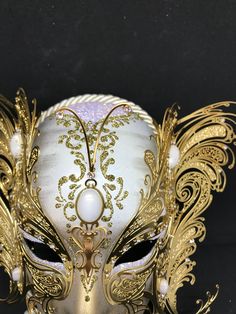 Venetian Mask for decoration - Traditional and original papier-mache Venetian mask, handmade and decorated with metal insert, gold-leaf and glitters,enriched with Swarovski crystals. Dimension::Hight 31cm,width 24cm Decoration only,not wereable All our masks are handmade papier-machè masks made in Venice. Our decorators use techniques typical of the Venetian tradition such as stucco, acrylics, gold and silver-leaf, macramè, passementerie, glitters and crequelè to offer you a wide range of origin Gold Mask For Mardi Gras Evening, Gold Masks For Mardi Gras Evening, Gold Masks For Mardi Gras Evening Events, Elegant Gold Masquerade Mask As Gift, Formal Gold Eye Mask, Gold Venetian Masquerade Mask For Formal Occasions, Gold Fantasy Style Masquerade Mask, Gold Fantasy Style Masquerade Mask For Party, Gold Fantasy Masquerade Mask For Party