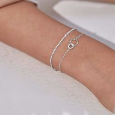 This gorgeous Infinity Bracelet offers a unique and timeless way to express your love or friendship. Crafted from two interlocking hoops, one pave encrusted and one polished, this bracelet boasts an incomparable sparkle combined with classic elegance. An ideal present for any special occasion, it's a luxurious reminder of the infinite bond between you and your loved one. All sterling silver jewellery will tarnish (oxidise) over time as this is the metal's natural way of reacting to the oxygen in June Birthstone Jewelry, Sterling Silver Jewellery, Jewelry Ring Box, Pearl Jewellery Earrings, Men's Jewelry Rings, Evil Eye Jewelry, Mens Jewelry Bracelet, Eye Jewelry, June Birth Stone