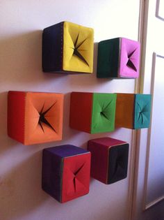 several colorful cubes are hanging on the wall