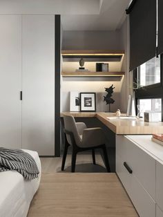 a bedroom with a bed, desk and chair next to a wall mounted book shelf