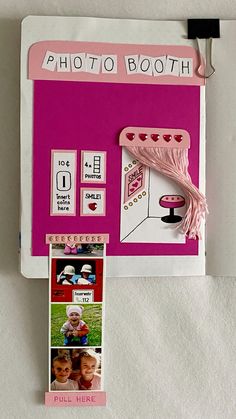 a pink photo booth with pictures on the front and back side, hanging from a hook