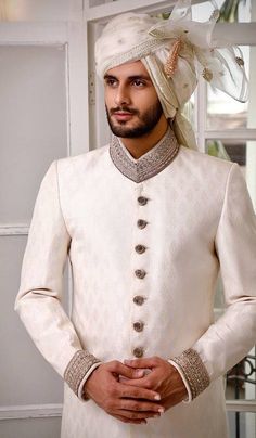 Fitted Sherwani With Intricate Embroidery And Long Sleeves, Cream Bandhgala With Long Sleeves For Diwali, Cream Long Sleeve Bandhgala With Resham Embroidery, Fitted Long Sleeve Sherwani With Intricate Embroidery, Traditional Cream Long Sleeve Sherwani, Cream Long Sleeve Bandhgala For Diwali, Traditional Long Sleeve Cream Sherwani, Fitted Embroidered Cream Churidar, Cream Long Sleeve Sherwani For Transitional Season