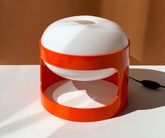 an orange and white object sitting on top of a table