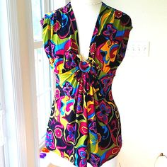 This Beautiful Colorful Printed Top Looks Like The 60's As Far As The Style Of Fabric. In The Middle The Fabric Is Brought Together With A Metal Gold Snake With Red Eyes. The Is The Slightest Cap Sleeve. The Top Measures Pit To Pit 19". Waist 16.5", And Length Of Top Is 25". Washing Instructions Are Hand Wash Gently. The Fabric Is 95% Polyester And 5% Spandex. Just A Gorgeous Blouse! It's Like Brand New! Fitted V-neck Blouse In Multicolor Print, Chic V-neck Top With Bold Print, Fitted Multicolor Floral Print Tank Top, Floral Print Sleeveless Tank Top For Party, Vibrant Fitted Multicolor Tops, Fitted V-neck Blouse With Vibrant Print, Multicolor Print Top For Party, Summer Fitted Blouse With Bold Print, Colorful Fitted Beach Top