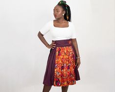 Imagine stepping into a lively art gallery, surrounded by masterpieces that awaken your senses. Our 'Aurora Pleats' midi wrap skirt invites you on a journey through a spectrum of colours and patterns reminiscent of an exquisite painting that comes to life. Each skirt is a canvas of rich orange tones embellished with designs that swirl across the fabric like the works of a skilled artist's brush. Some sections feature a mix of plain fabric, adding depth and contrast, while others present the same Midi Wrap Skirt, Orange Tones, Artist Brush, Plain Fabric, The Works, Dress Clothes For Women, Wrap Skirt, Aurora, Favorite Outfit