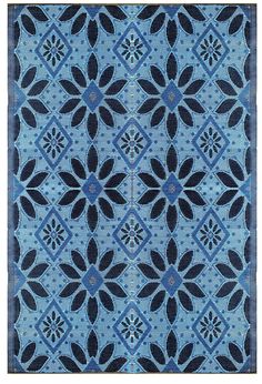 a blue and black rug with flowers on it