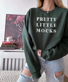 Green Letter Print Crew Neck Sweater, Green Cotton Sweater With Graphic Print, Green Sweater With Letter Print In Relaxed Fit, Green Relaxed Fit Sweater With Letter Print, Trendy Green Sweatshirt With Text Print, Green Text Print Sweatshirt For Winter, Green Winter Sweatshirt With Text Print, Green Branded Sweatshirt For Winter, Green Casual Sweatshirt With Branding