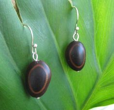 "The guanacaste is one of Nicaragua's most imposing trees, standing strong, it is noticed among others. The seed pod is know as the \"ear\" of the tree because of its shape. The seeds found inside the pod have a natural \"eye\" design, many people call them \"deer eyes.\" They are great everyday earrings - they match black and brown, and go great with other colors. Sterling silver ear wires come with \"stoppers\" so you won't lose your earrings. Like this design but want to modify it for your pe Nature-inspired Brown Earrings With Ear Wire, Handmade Oval Brown Earrings, Handmade Black Earthy Jewelry, Deer Eyes, Seed Pod, Organic Jewelry, Perfect Pies, Organic Seeds, Natural Eyes