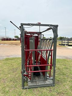 the back end of a red tractor with its doors open