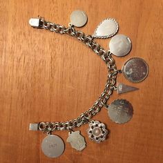 "This vintage sterling silver charm bracelet is from the 60's. It has 9 sterling silver charms including a small round disc with a cougar, Niagara Falls enameled ,expo 67 Montreal Canada, disc with engraved\"Shelly\" 12_19_65, Happy Birthday from Barbara 3-4-66, mustard seed, Debate N. F. L. 1969, Sr. High Chorus 1969. The bracelet is 7.5\" long on a double link chain with a very secure lock. This probably is a bracelet from Canada judging from the engraving. A very unique collection of charms . Vintage Medallion Charms, Collectible Sterling Silver Jewelry With Vintage Charm, Vintage Sterling Silver Bracelet With Charm, Sterling Silver Vintage Charm Bracelet, Sterling Silver Jewelry With Vintage Charm For Collectors, Sterling Silver Jewelry With Vintage Charm, Silver Vintage Bracelets With Vintage Charm, Silver Engraved Charms For Collectors, Sterling Silver Bracelets With Dangling Charms For Collectors