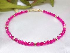 14kt Gold Fuschia Anklet 1`4kt Gold Hot Pink Ankle Bracelet Pink Crystal Anklet Crystal Ankle Bracelet 14kt Gold Anklet BuyAny3+Get1 Free 14kt gold fuschia anklet is made with Hot Pink Fuschia Swarovski Crystals and 14kt gold beads. All metal is American Made 14kt Gold. It fastens with a 14k Gold Spring Ring clasp or lobster clasp. You choose which clasp. Select Size and clasp style. When you purchase a combination of any 3 items, you will receive 1 additional item for free. Do not Purchase the Pink Anklet, Hot Pink Bracelets, Crystal Anklet, White Pearl Bracelet, Ankle Jewelry, Gold Anklet, Bridesmaid Bracelet, Ankle Bracelet, Anklet Jewelry