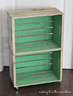 a green cabinet sitting on top of a hard wood floor