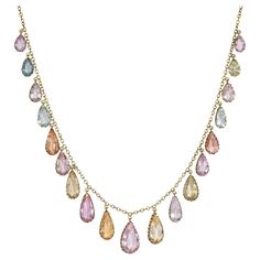 An antique Victorian period gold and topaz necklace of fringe design, comprising graduated precious topaz pear-shaped drop pendants in an array of pastel colors, in 14k. Largest stone measures approximately 16mm long x 10mm at widest point; smallest is about 8mm long x 4mm at widest * Includes letter of authenticity * Free shipping Festoon Necklace, Victorian Period, Topaz Necklace, Fringe Necklace, Pearl Diamond, Drop Necklace, Drop Pendant, Antique Victorian, Pear Shaped