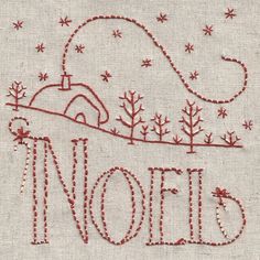 the word noel written in red thread on white linen