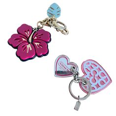 two heart shaped key chains with flowers on them