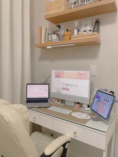 a computer desk with two laptops and a monitor on it, in front of a white chair