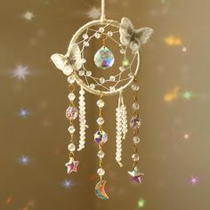 a dream catcher with butterflies and stars hanging from it